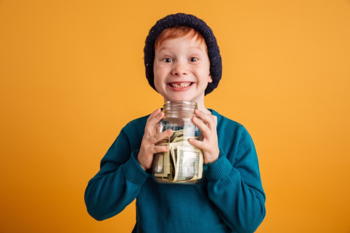 kid holding a jar full of money